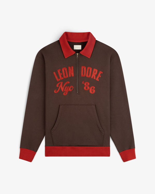 Brown Chainstitch ’86 Half Zip Pullover with a red collar, cuffs, and hem, featuring Leon Dore Nyc 86 on the chest.