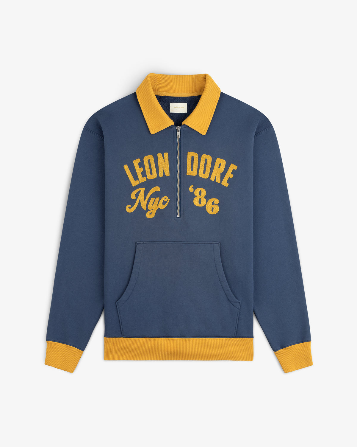 Blue Chainstitch ’86 Half Zip Pullover with a gold collar, cuffs, and hem, featuring LEON DORE Nyc 86 in gold lettering.