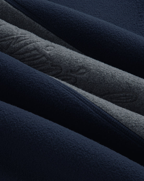Close-up of a navy and grey Fleece Script Paneled Crewneck Sweatshirt with embroidered script detailing.