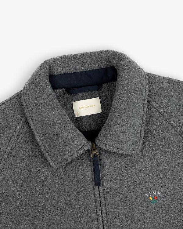 Close-up of a gray Crest Fleece Casual Jacket with collar, zipper, and small AIME chest logo.