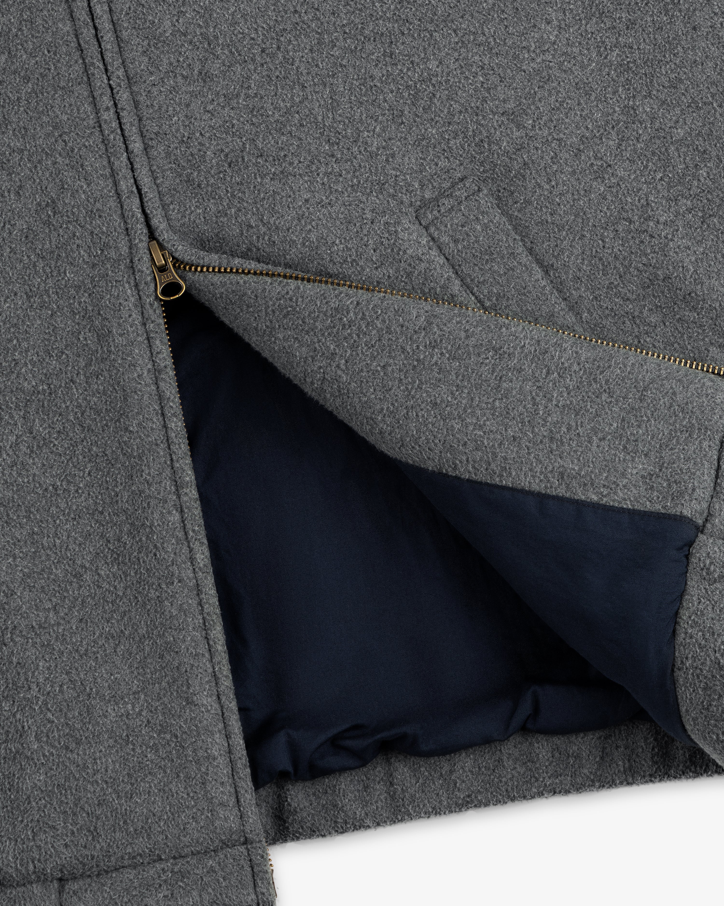 Close-up of Crest Fleece Casual Jacket: gray with a gold zipper, dark blue lining, and visible interior pocket.
