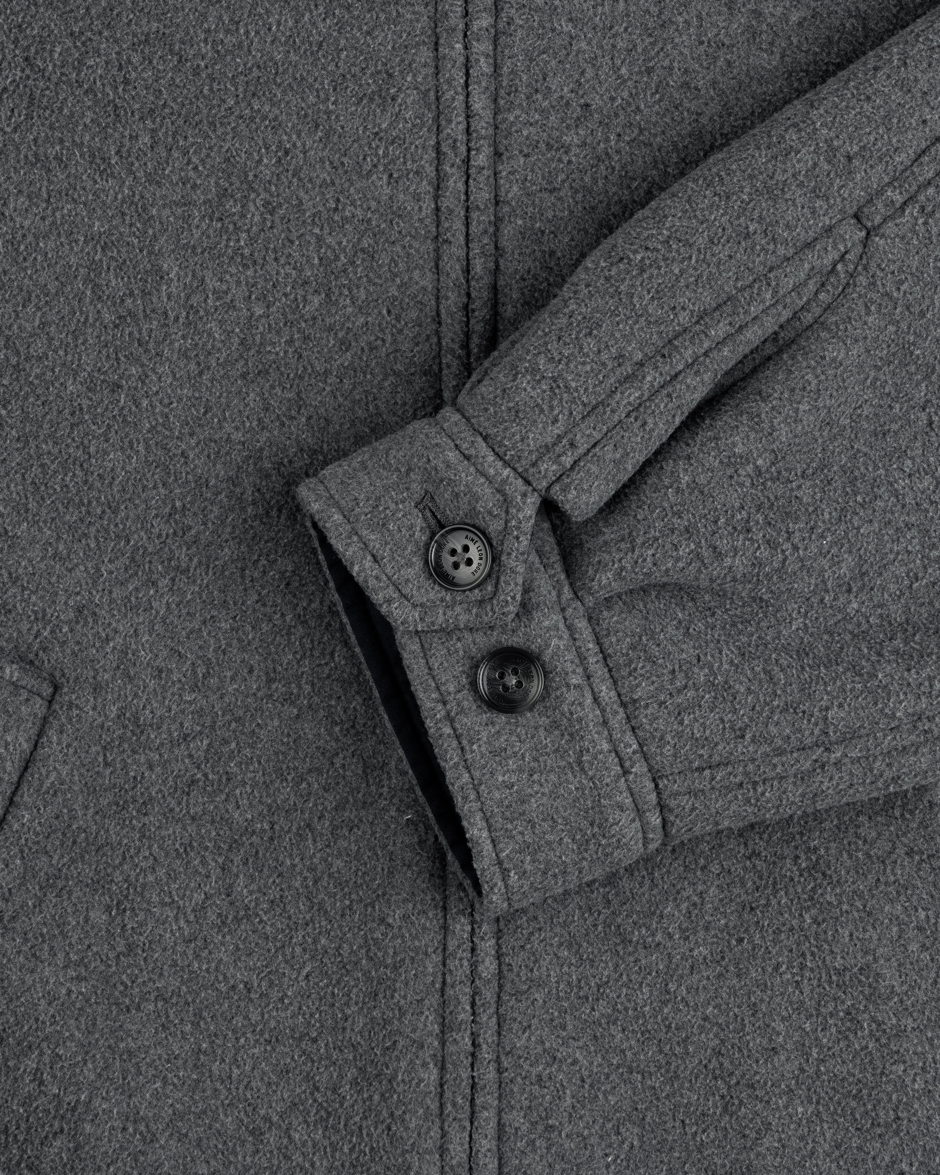 Close-up of Crest Fleece Casual Jacket sleeve in gray, showing two black buttons and a partially visible pocket.