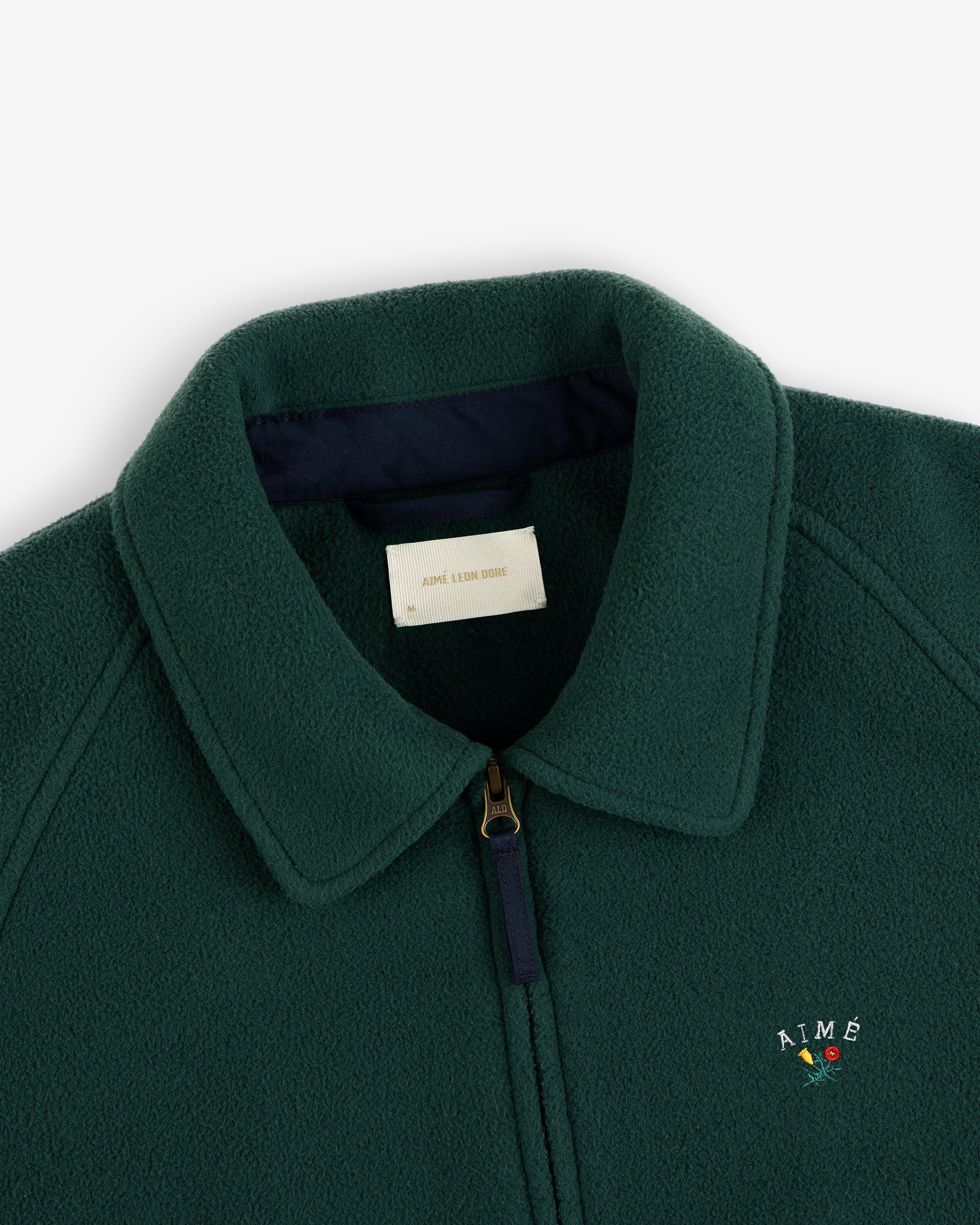 Crest Fleece Casual Jacket in dark green with collar, zipper, and AIMÉ plus red rose embroidered on the chest.