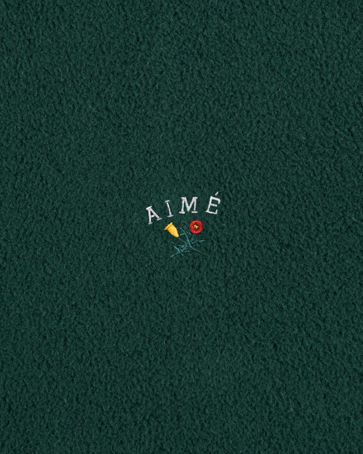 Green fleece Crest Fleece Casual Jacket with AIMÉ text embroidered above a yellow flower and red rose.