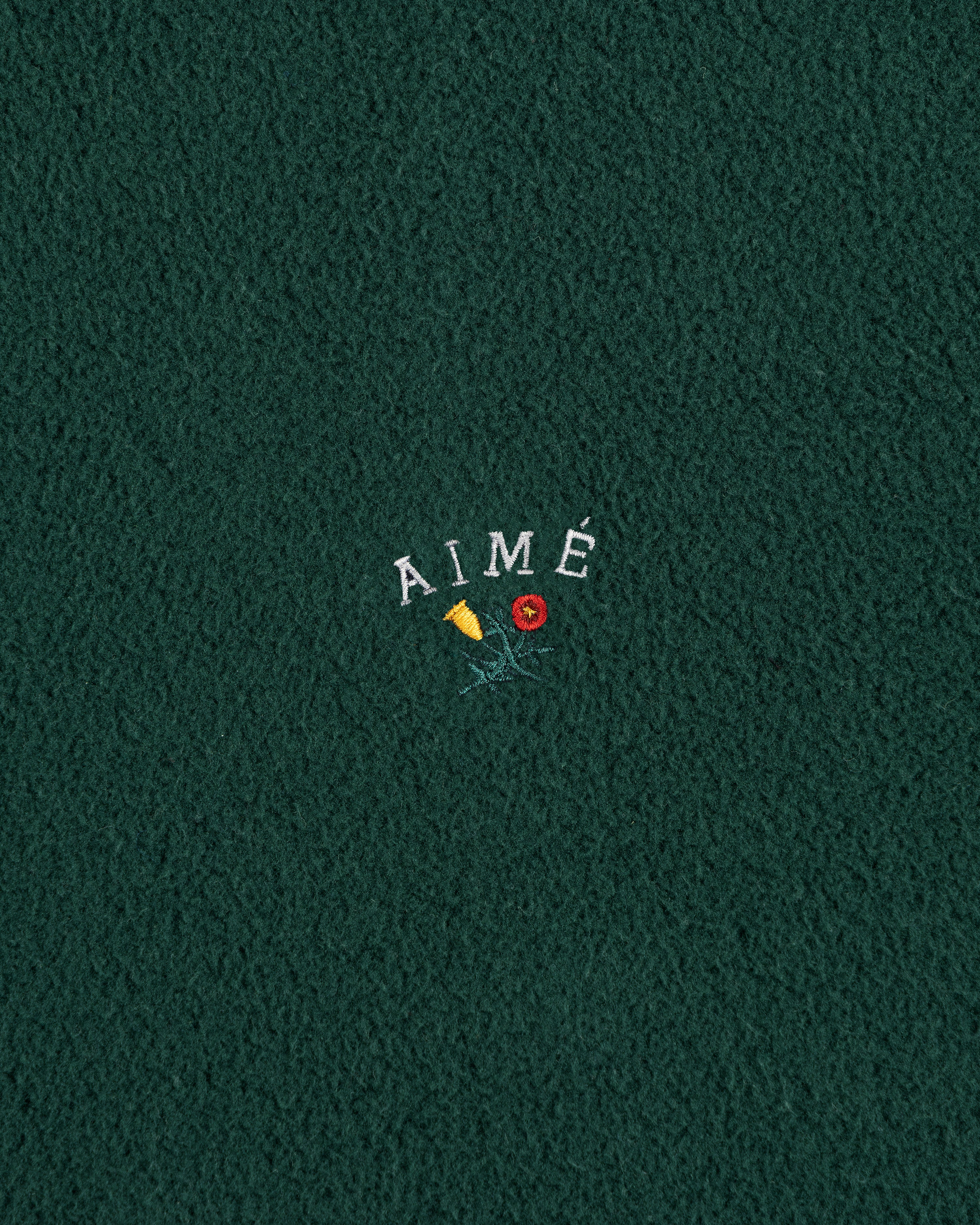Green fleece Crest Fleece Casual Jacket with AIMÉ text embroidered above a yellow flower and red rose.