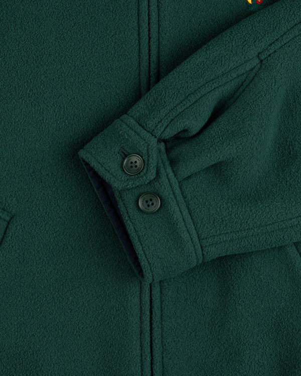 Close-up of a Crest Fleece Casual Jacket sleeve, dark green with 2 black cuff buttons and textured fabric.