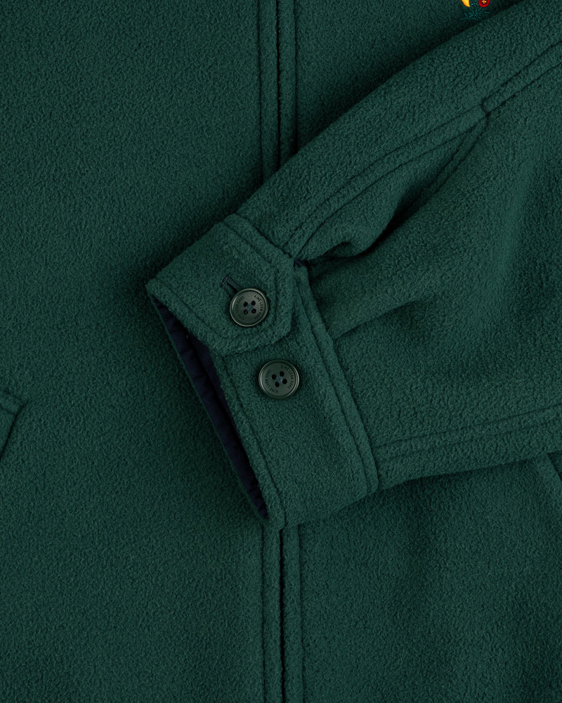 Close-up of a Crest Fleece Casual Jacket sleeve, dark green with 2 black cuff buttons and textured fabric.