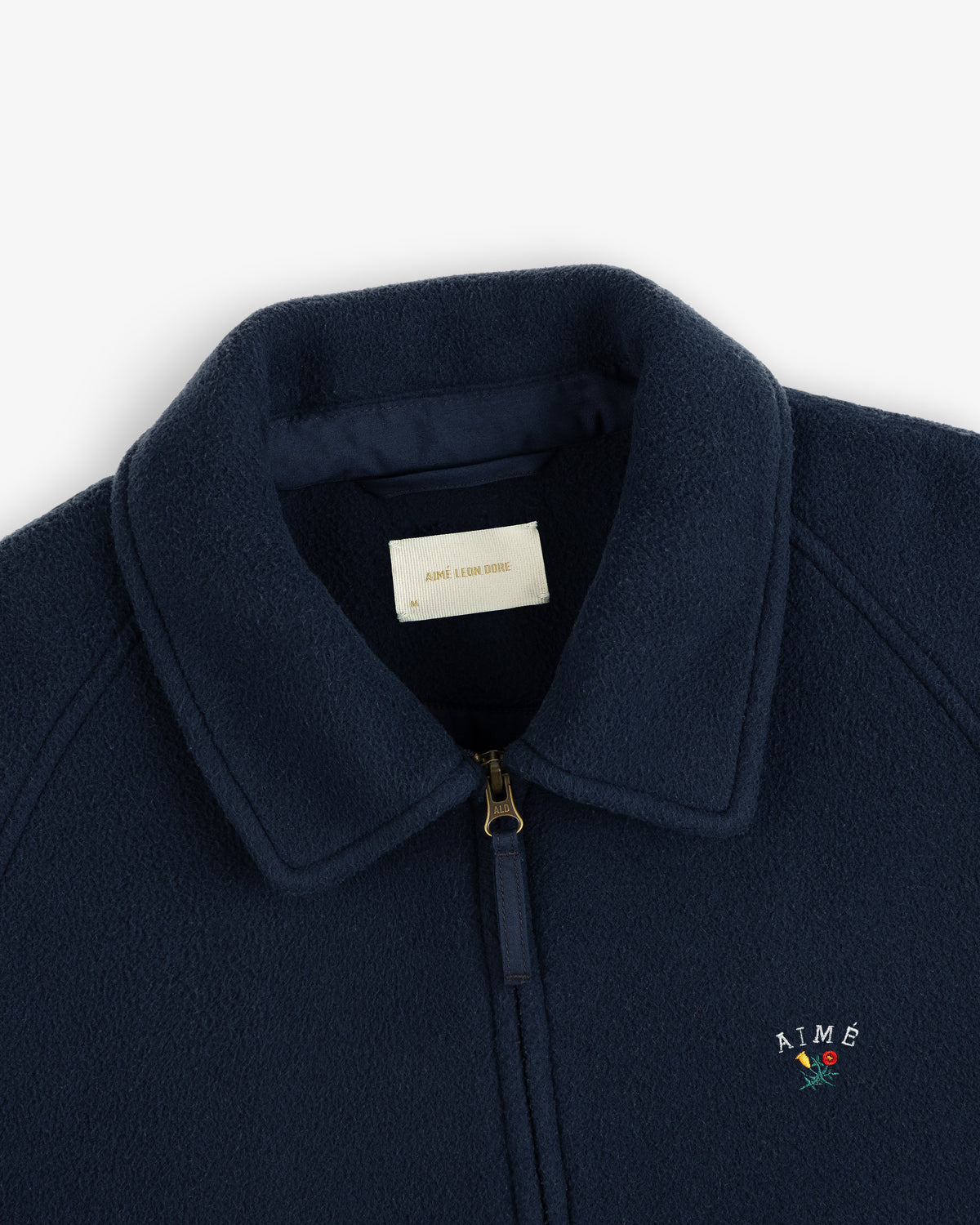 Crest Fleece Casual Jacket in navy blue with zipper, collar, and AIMÉ rose embroidered logo.