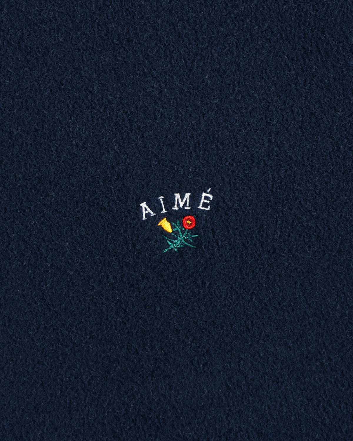 Navy Crest Fleece Casual Jacket with AIMÉ embroidered above a yellow-red flower with green stem and leaves.