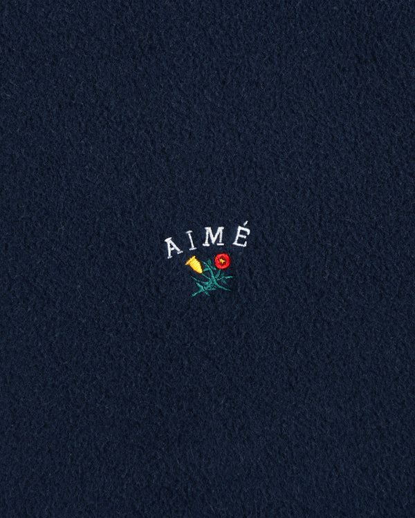 Navy Crest Fleece Casual Jacket with AIMÉ embroidered above a yellow-red flower with green stem and leaves.