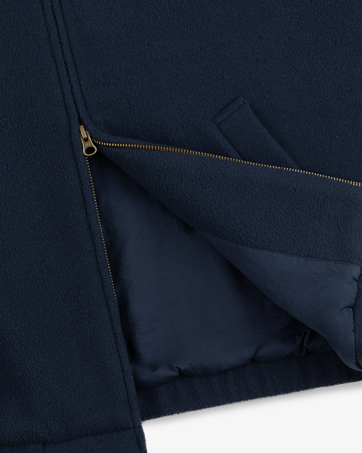 Crest Fleece Casual Jacket in navy blue, partially unzipped to reveal its interior lining and angled side pocket.