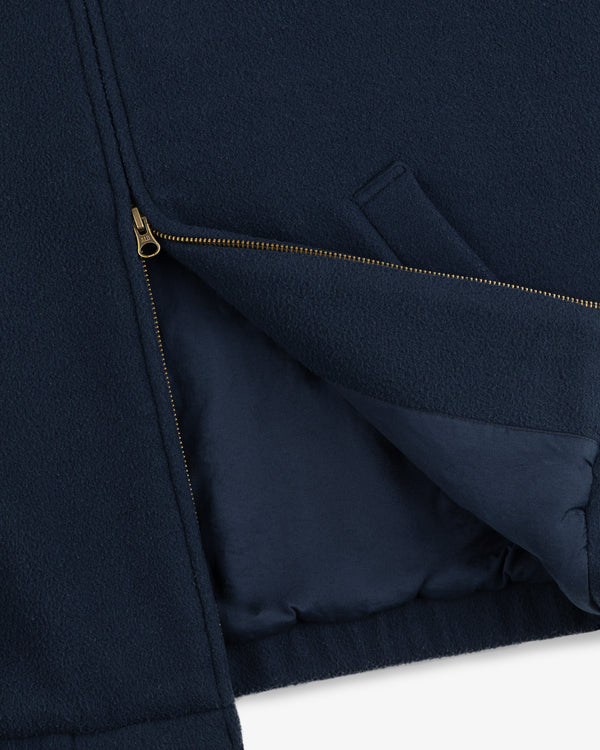 Crest Fleece Casual Jacket in navy blue, partially unzipped to reveal its interior lining and angled side pocket.