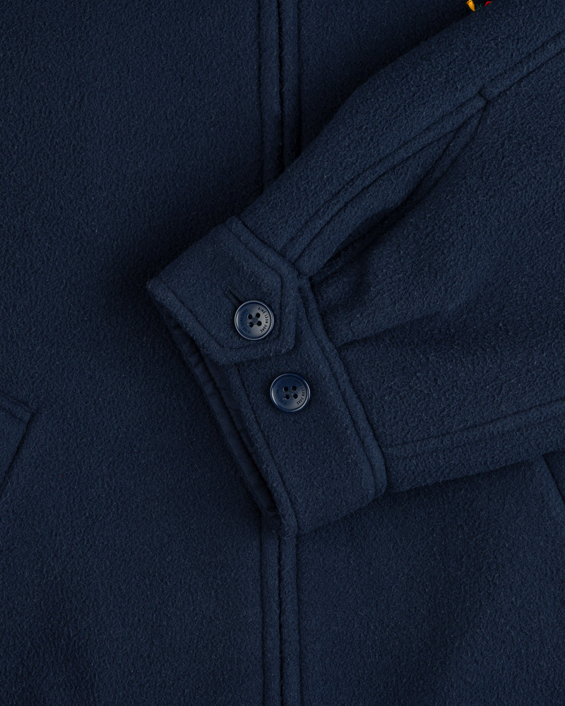 Close-up of Crest Fleece Casual Jacket in navy blue, showing two sleeve buttons and part of the pocket seam.