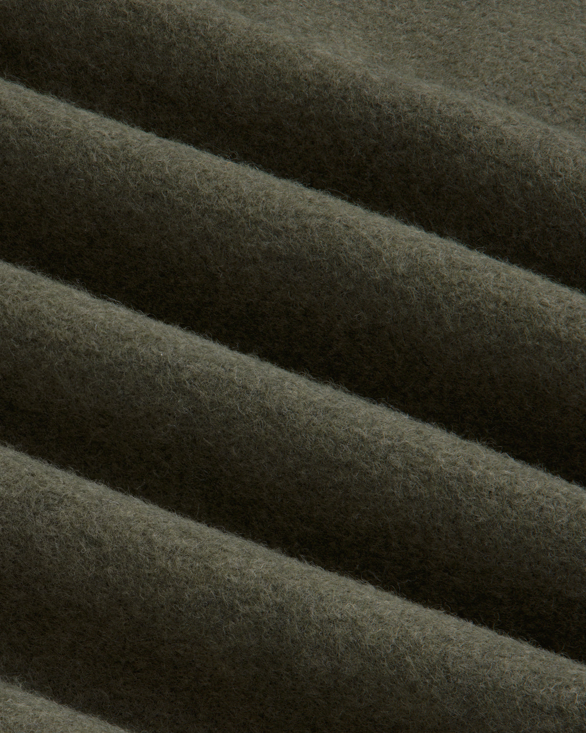 Olive green Surplus Fleece Quarter Zip Pullover fabric with soft diagonal folds.