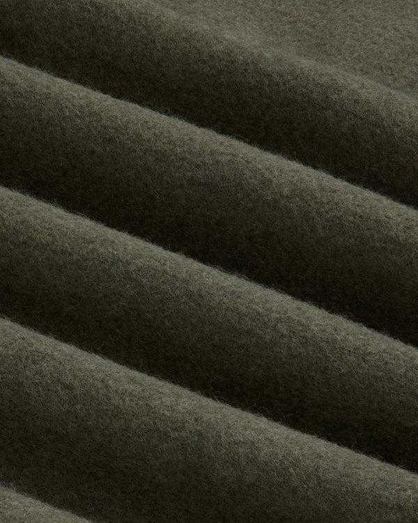 Olive green Surplus Fleece Quarter Zip Pullover fabric with soft diagonal folds.