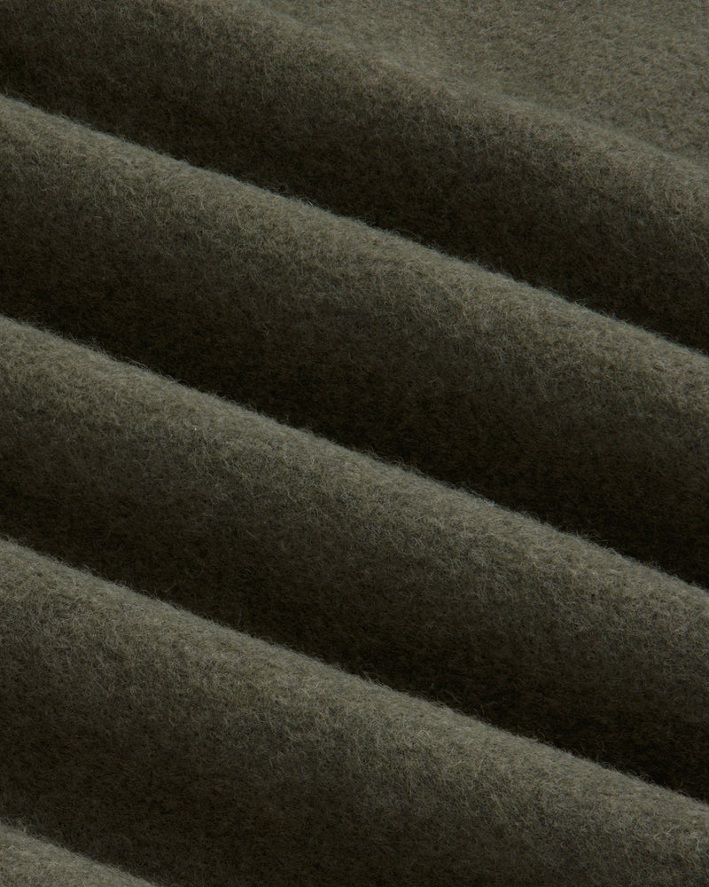 Olive green Surplus Fleece Quarter Zip Pullover fabric with soft diagonal folds.