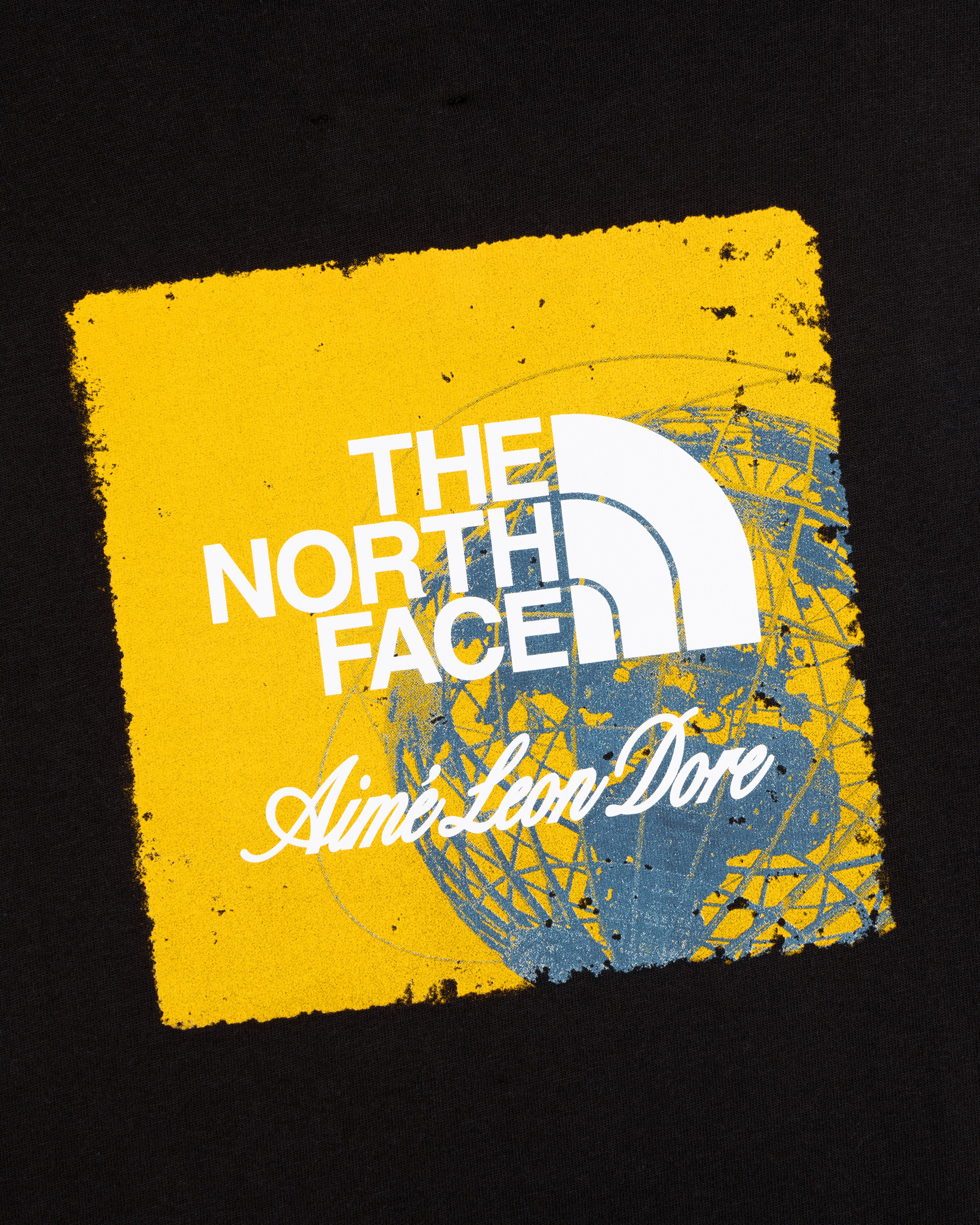ALD / The North Face Logo Tee: Yellow square logo with brand text over blue globe on black background.
