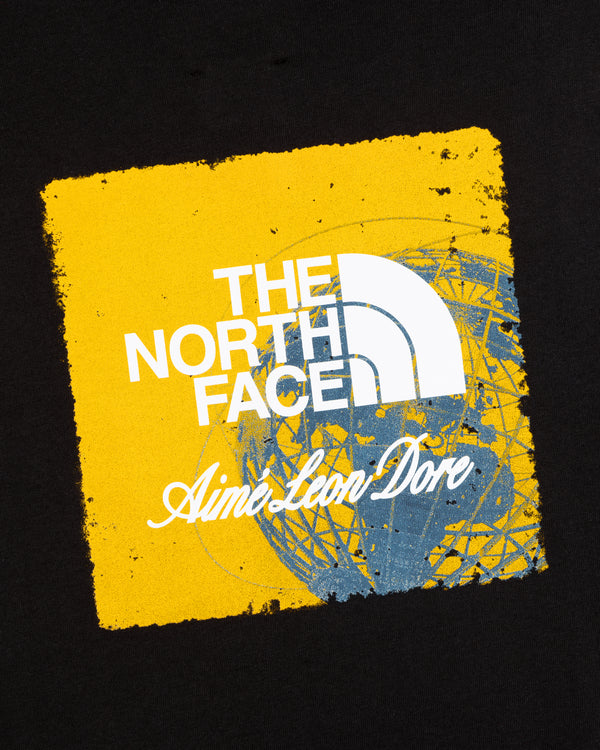 ALD / The North Face Logo Tee: Yellow square logo with brand text over blue globe on black background.