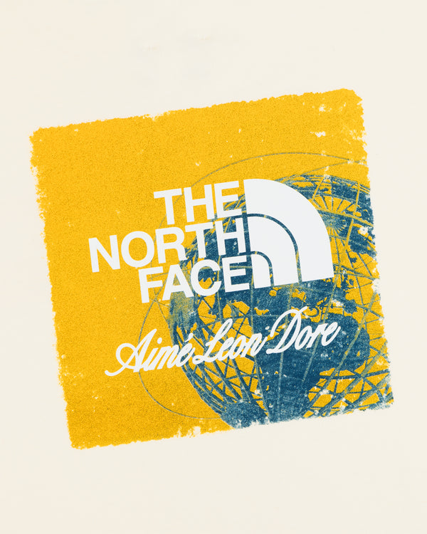 Cream ALD / The North Face Logo Tee with yellow square, blue abstract globe, and collab text.