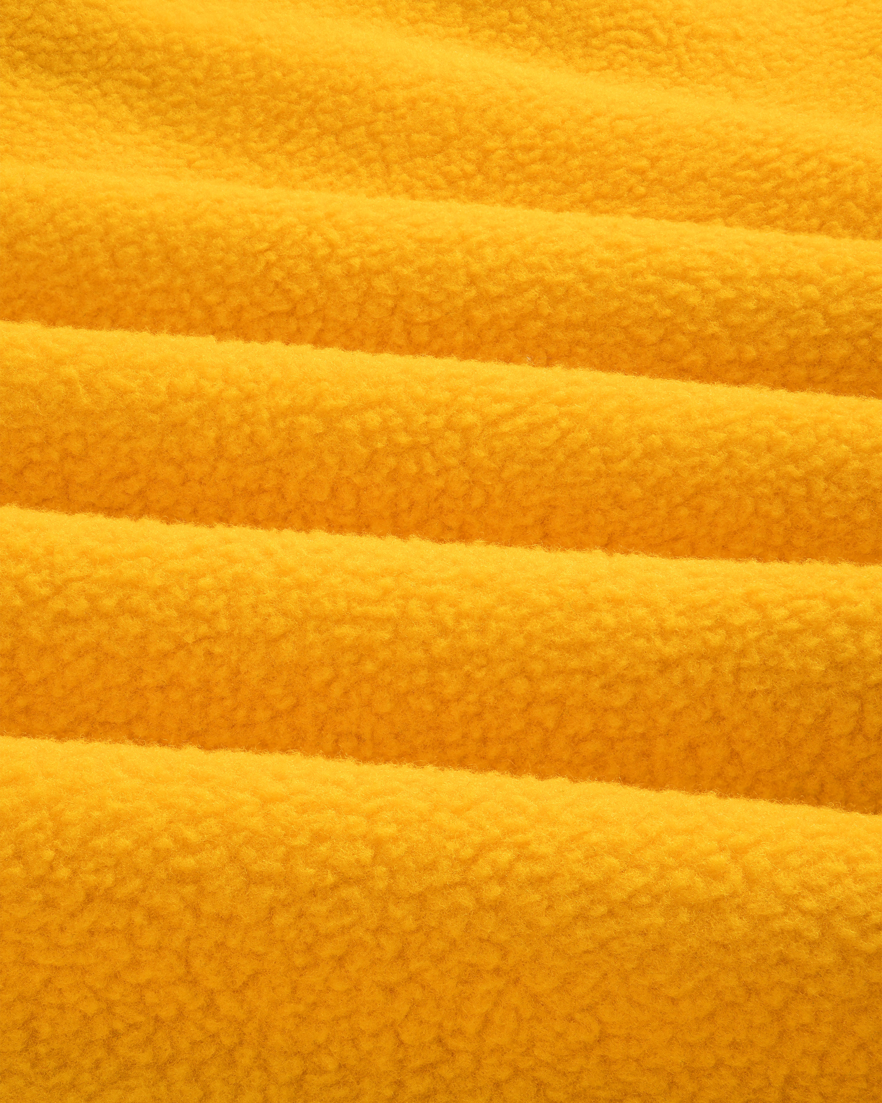 Close-up of ALD / The North Face Fleece Rugby in soft yellow fleece with gentle folds and a fluffy, textured look.