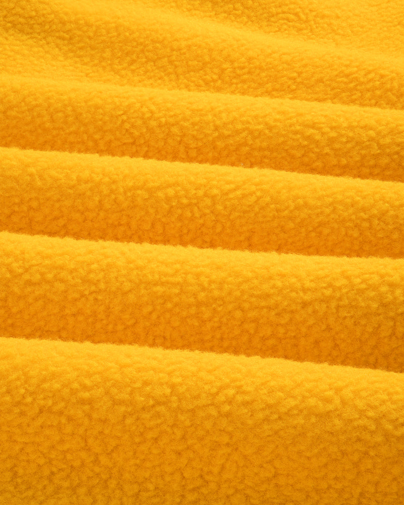 Close-up of ALD / The North Face Fleece Rugby in soft yellow fleece with gentle folds and a fluffy, textured look.