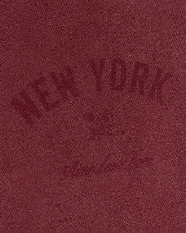 Maroon Yankees Washed Logo Tee with “New York” and “Aimé Leon Dore” text above and below a floral graphic.