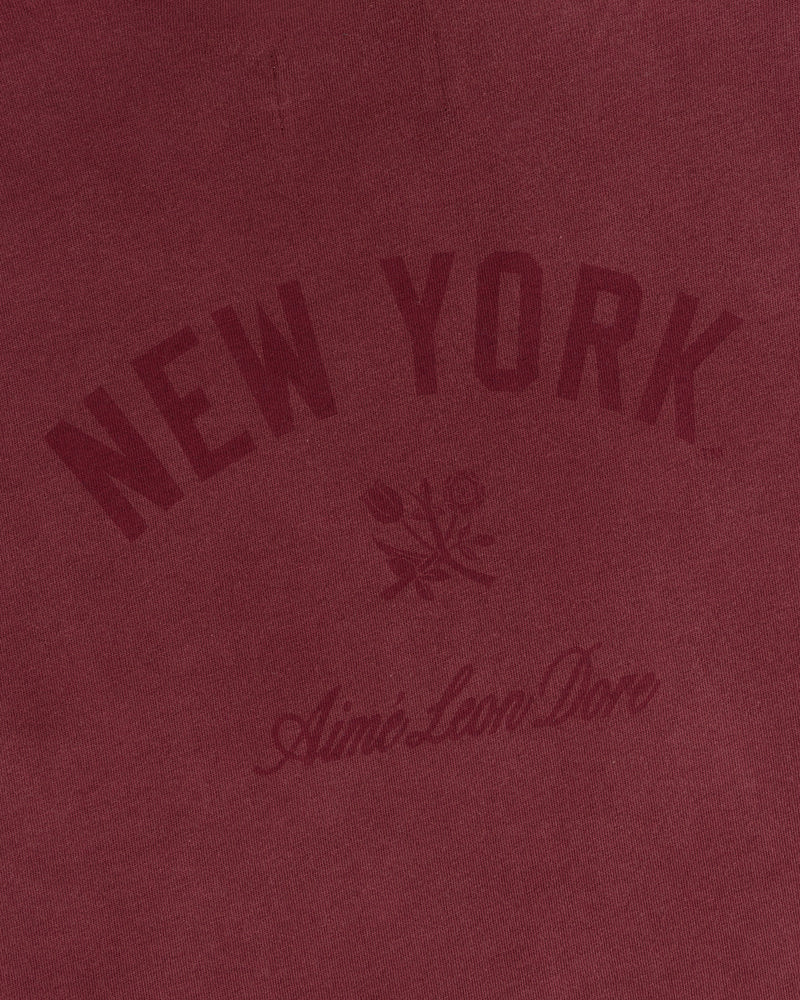 Maroon Yankees Washed Logo Tee with “New York” and “Aimé Leon Dore” text above and below a floral graphic.