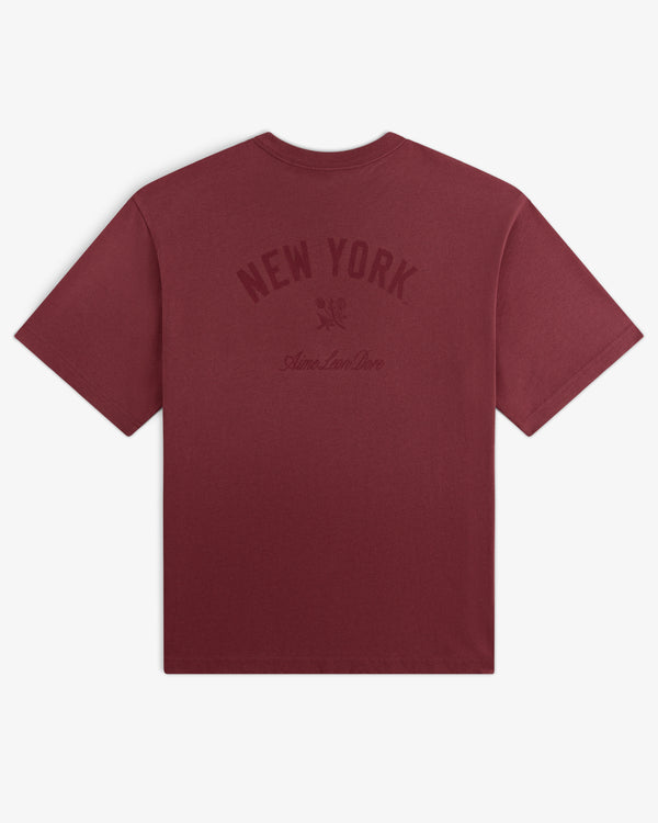 Yankees Washed Logo Tee in maroon with NEW YORK and Aimé Leon Dore text printed in dark red on the back.