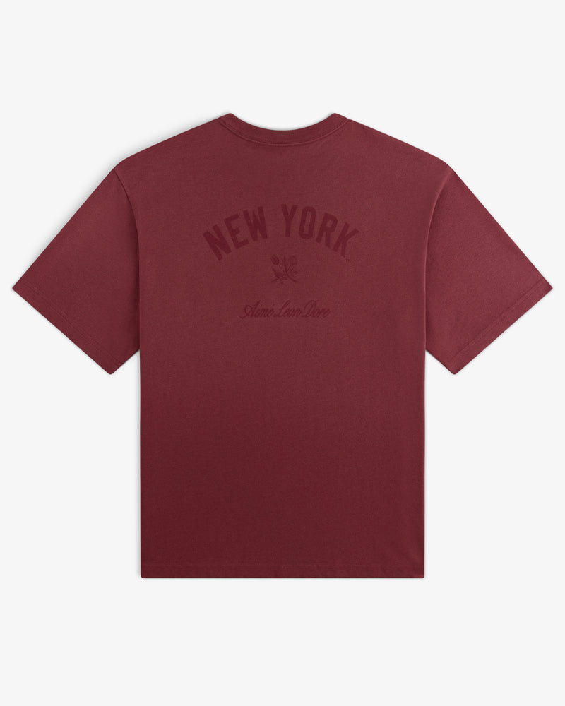 Yankees Washed Logo Tee in maroon with NEW YORK and Aimé Leon Dore text printed in dark red on the back.