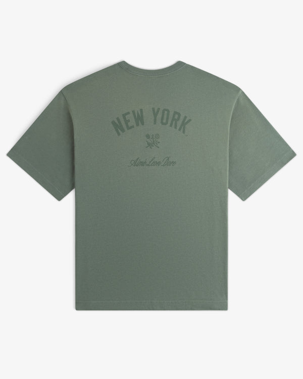 Yankees Washed Logo Tee: green shirt with NEW YORK, Aime Leon Dore text, and small upper back graphic.