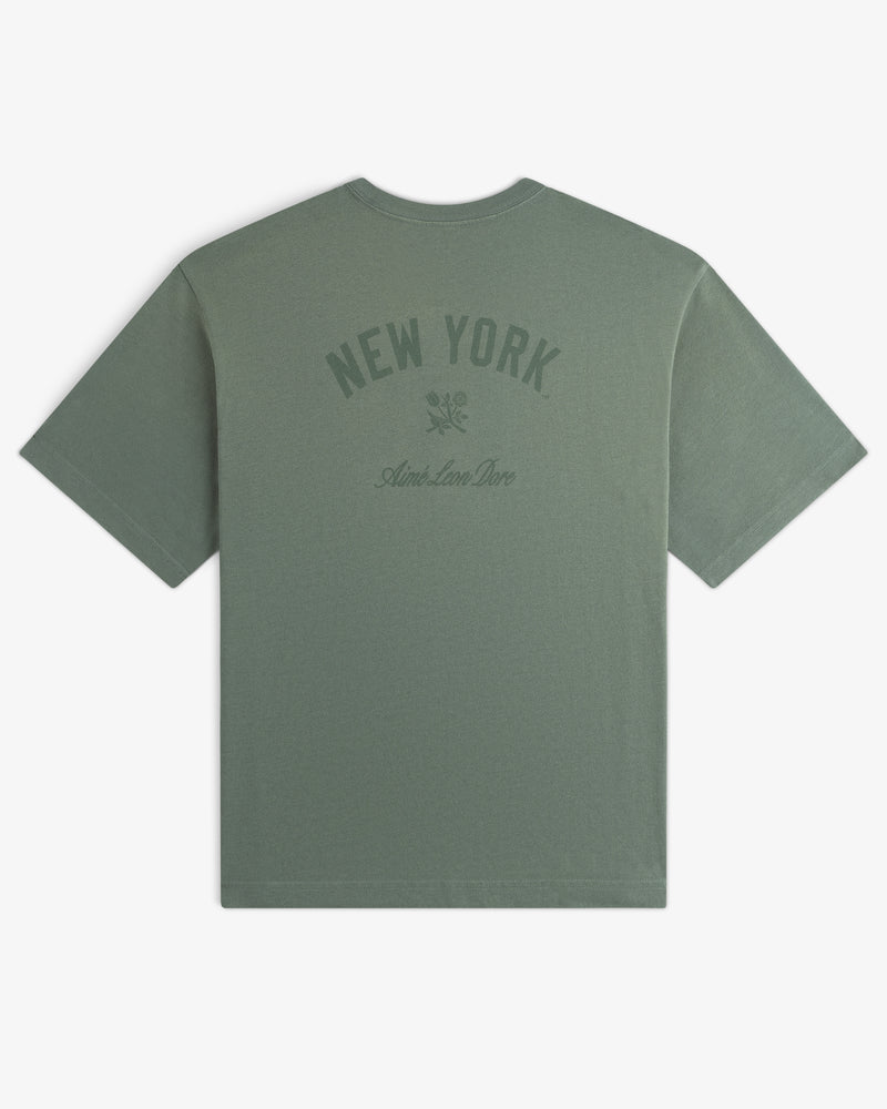 Yankees Washed Logo Tee: green shirt with NEW YORK, Aime Leon Dore text, and small upper back graphic.