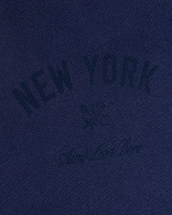 Yankees Washed Logo Tee in navy with NEW YORK, Aimé Leon Dore text, and a small rose graphic at the center.