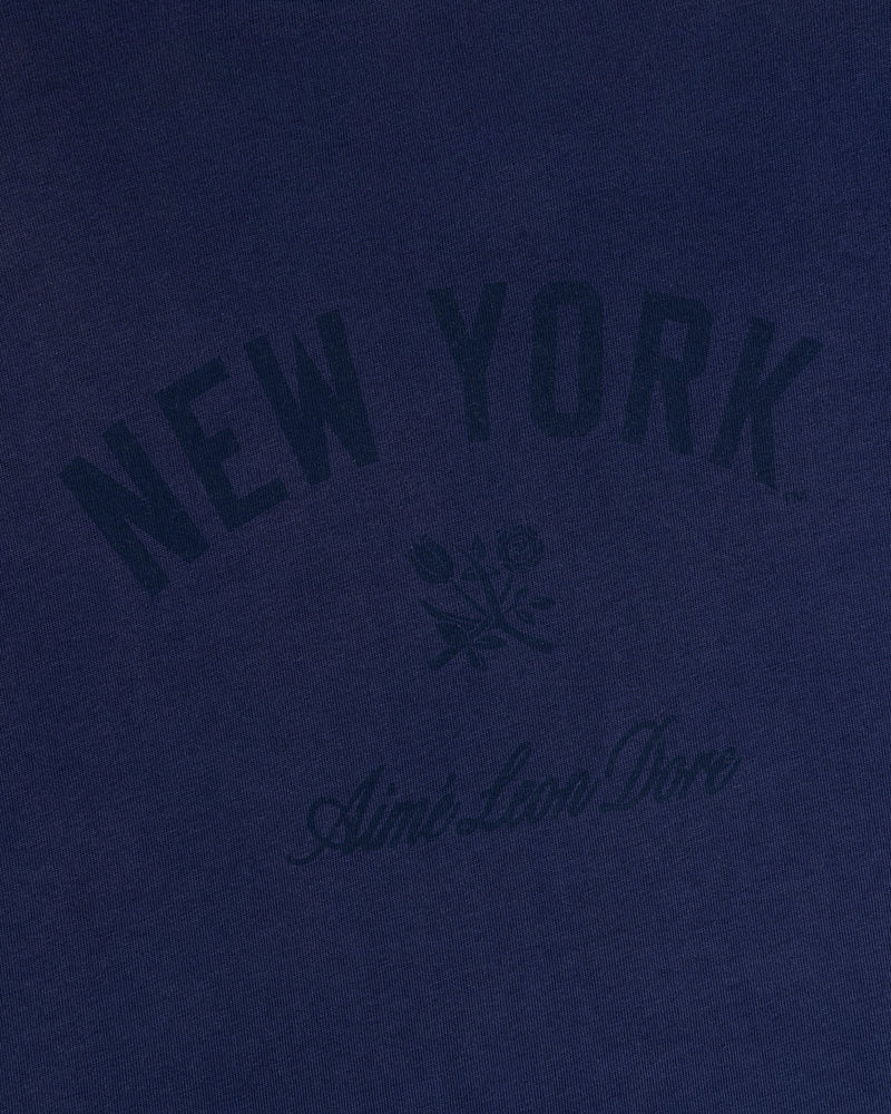 Yankees Washed Logo Tee in navy with NEW YORK, Aimé Leon Dore text, and a small rose graphic at the center.