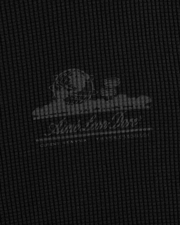 Faint white Unisphere logo and text on a dark, textured waffle thermal with grid pattern and cloud accents.