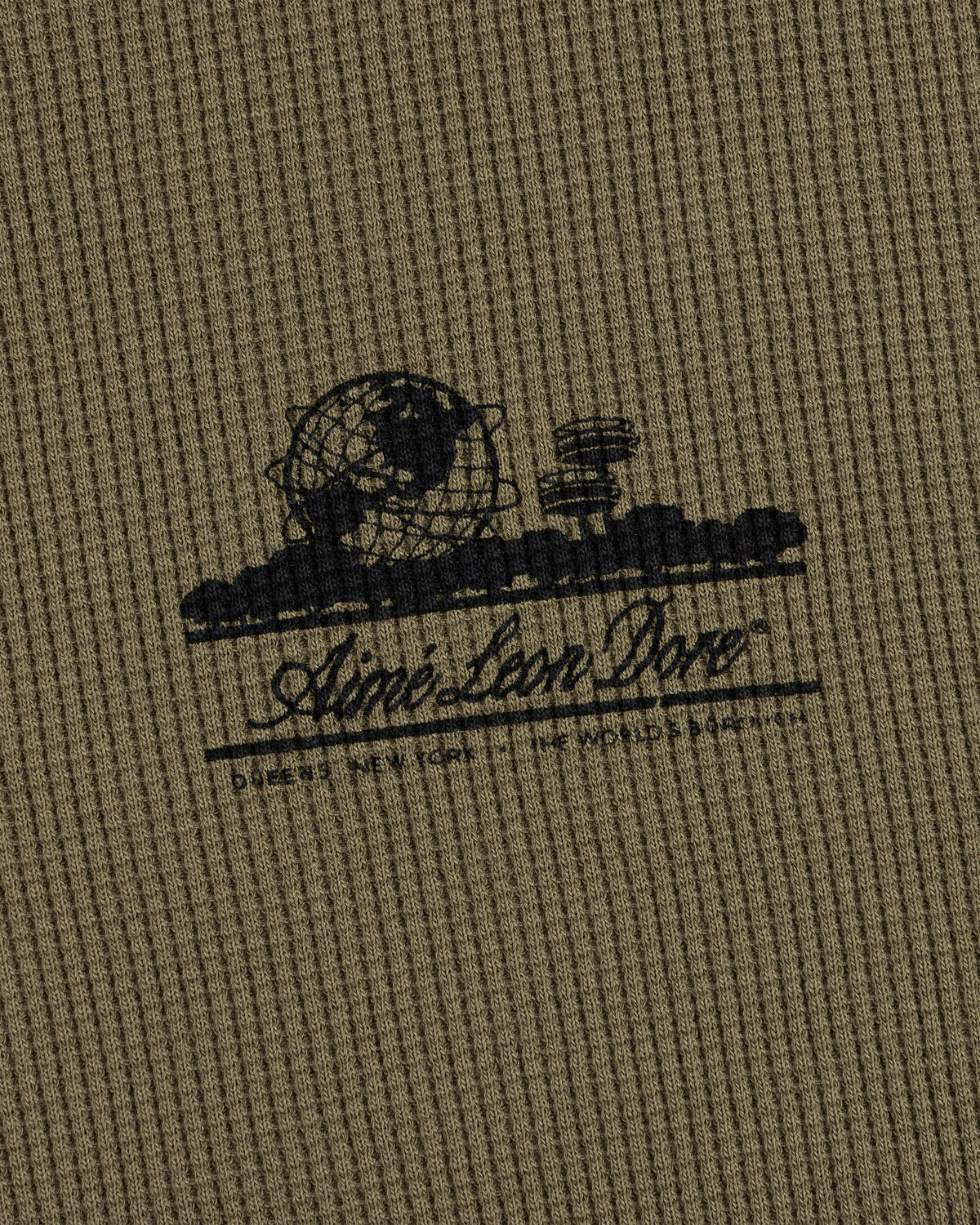 Olive-green waffle thermal with black Unisphere graphic and Ainé Bon Doné script on the front.