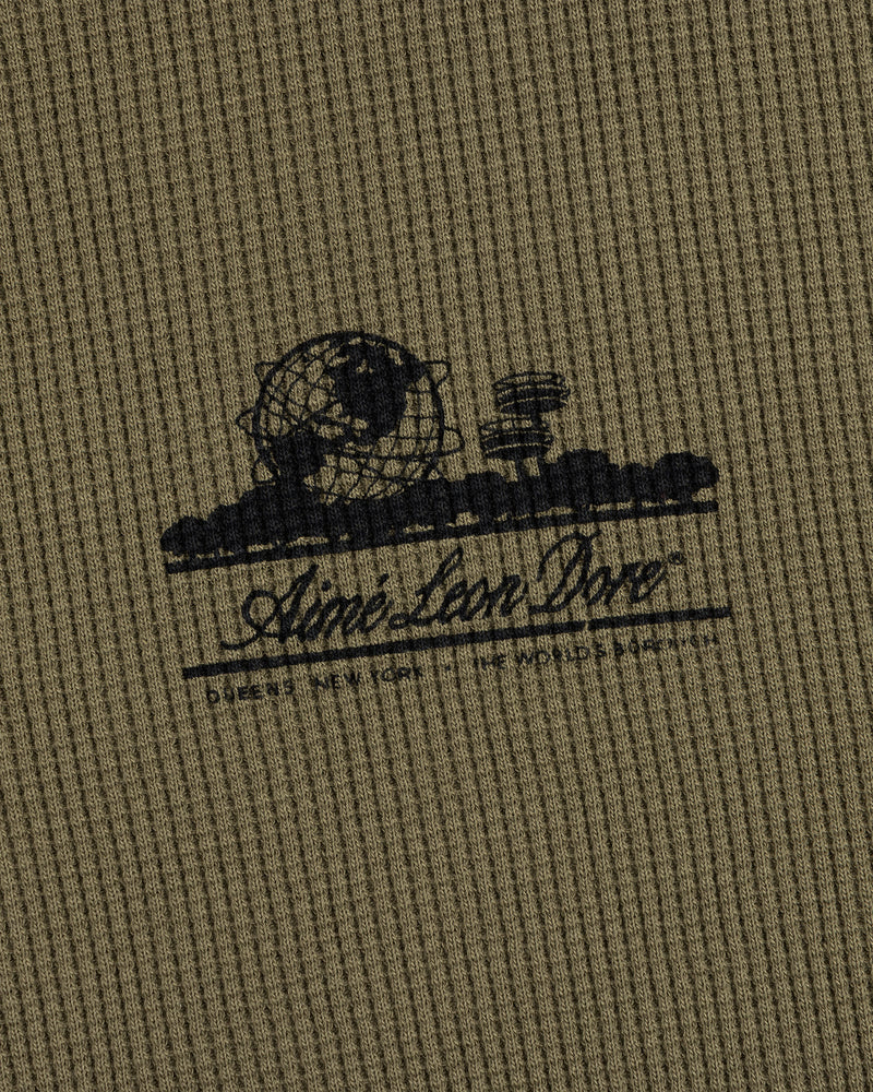 Olive-green waffle thermal with black Unisphere graphic and Ainé Bon Doné script on the front.