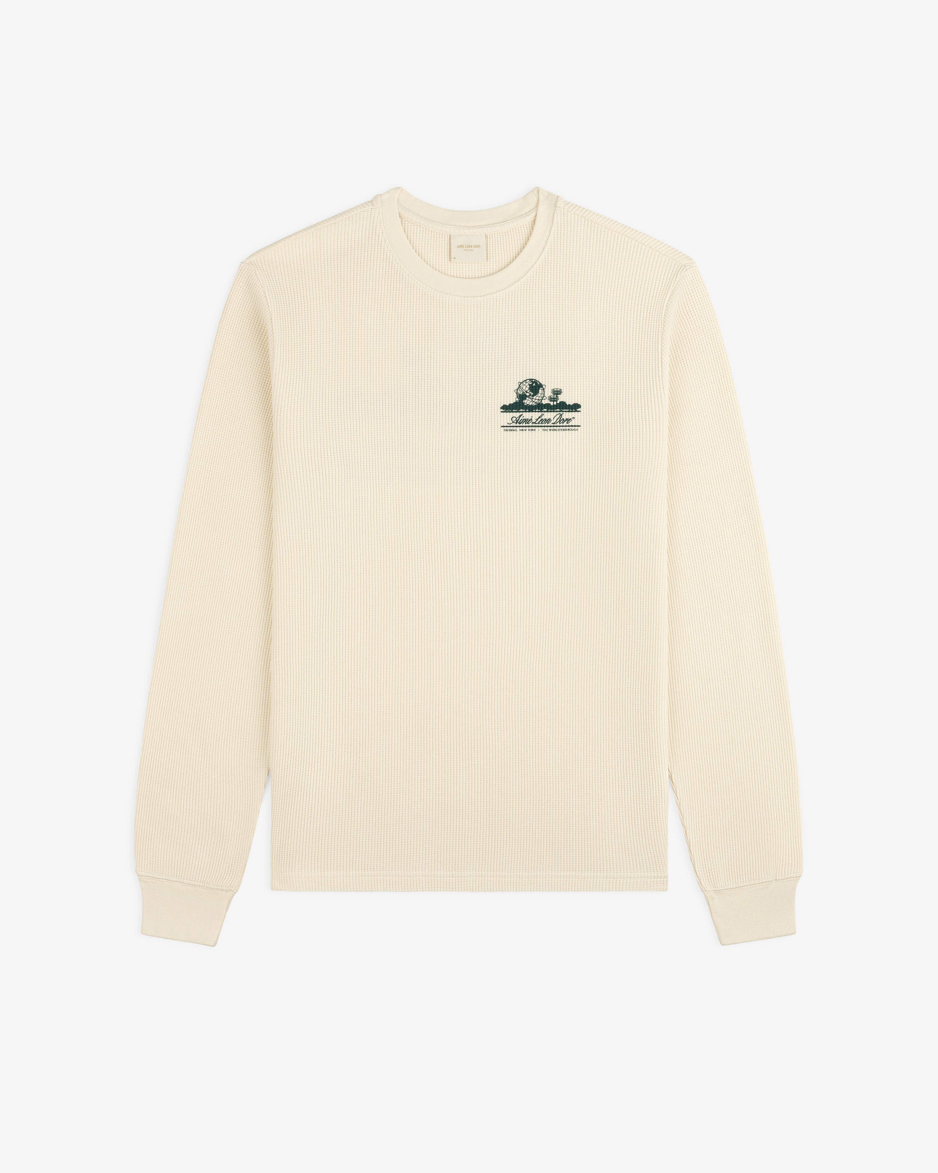 Ivory Long-Sleeve Unisphere Waffle Thermal with a small green embroidered graphic on the upper left chest.