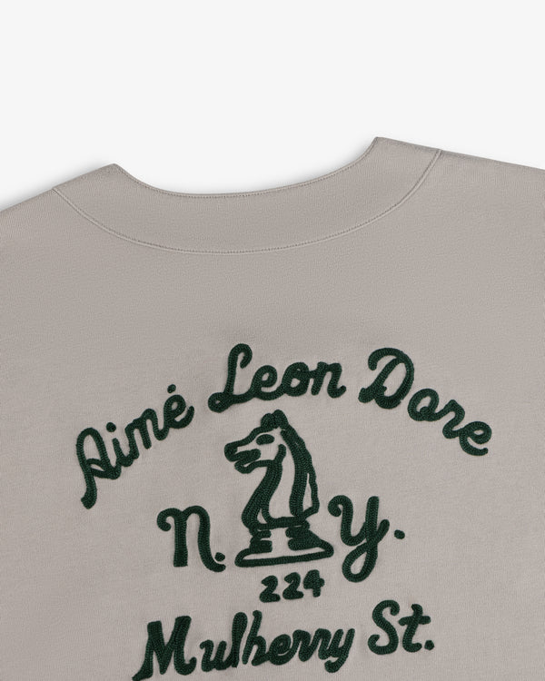 Beige Mulberry Chainstitch Baseball Jersey with dark green “Aimé Leon Dore N.Y.” and chess knight graphic.