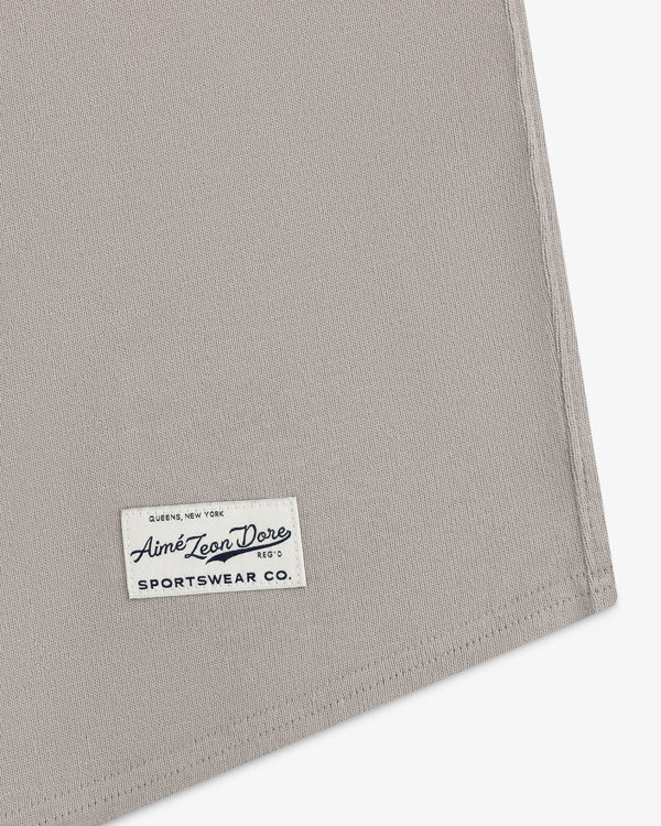 Beige Mulberry Chainstitch Baseball Jersey with a white Aimé Leon Dore Sportswear Co. label stitched in the corner.
