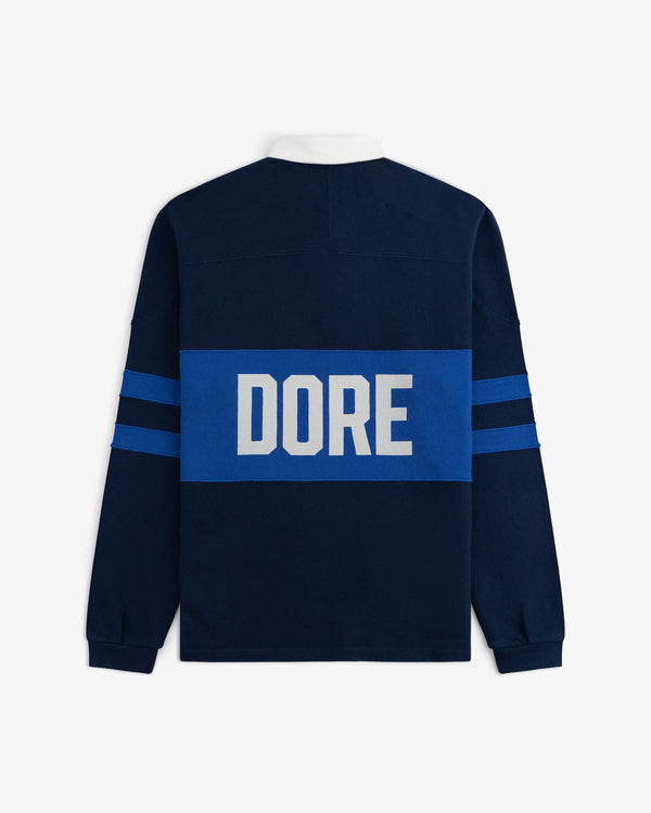 Leon Dore Collegiate Rugby: Navy long-sleeve shirt with blue stripes & “DORE” in large white letters on the back.