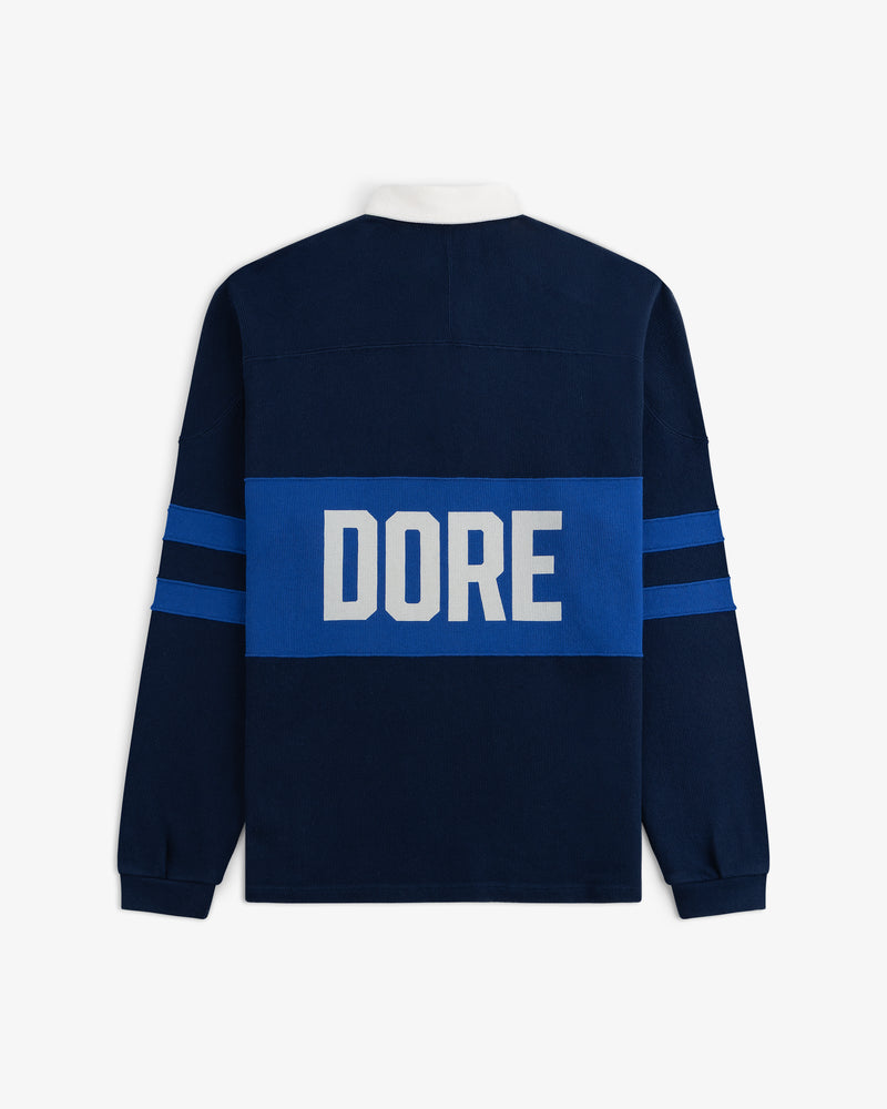 Leon Dore Collegiate Rugby: Navy long-sleeve shirt with blue stripes & “DORE” in large white letters on the back.