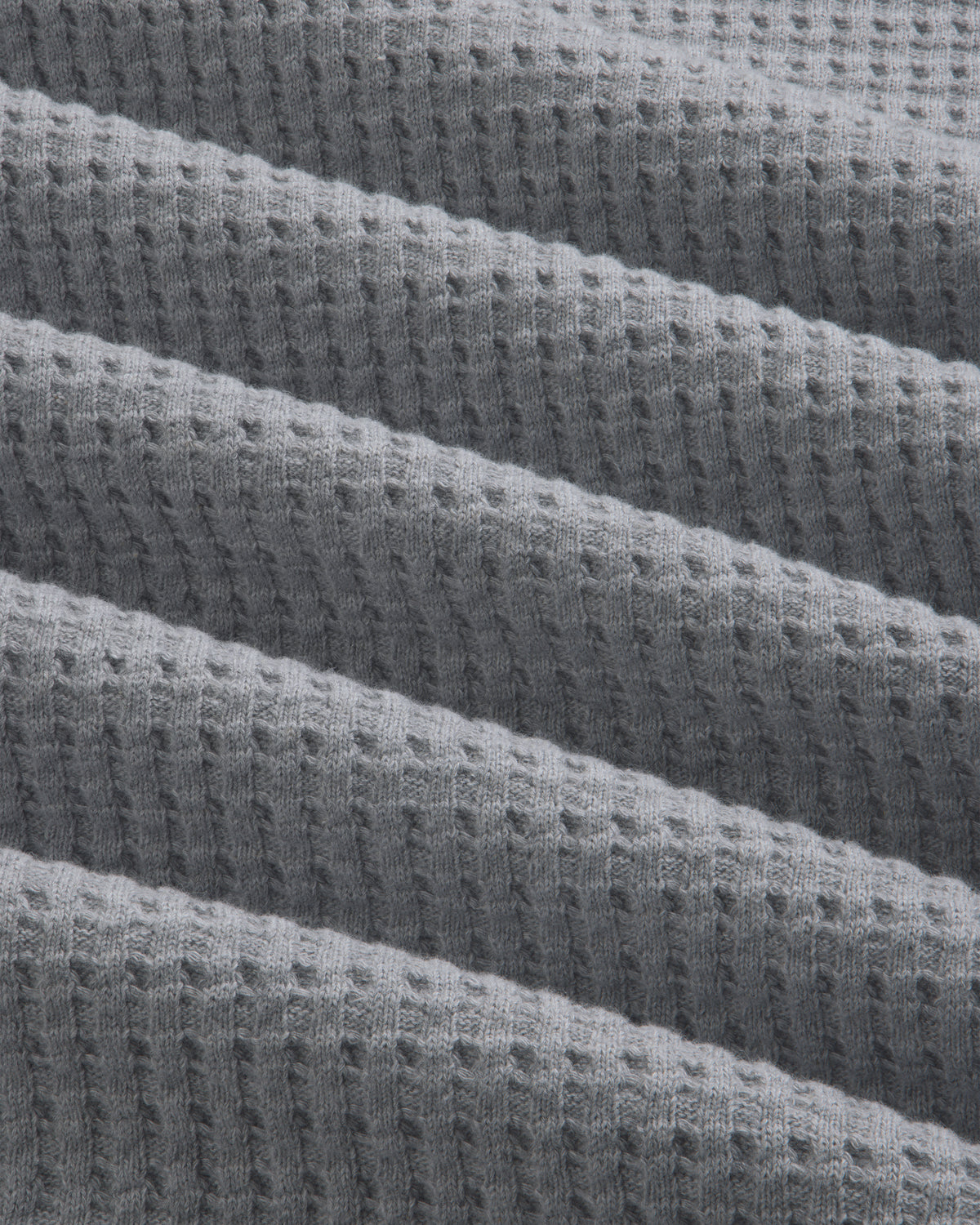 Grey Long-Sleeve Waffle Thermal fabric with diagonal folds.