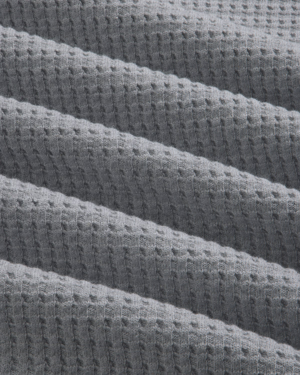 Grey Long-Sleeve Waffle Thermal fabric with diagonal folds.