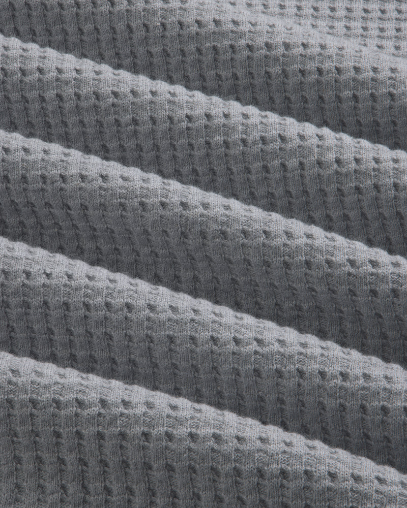Grey Long-Sleeve Waffle Thermal fabric with diagonal folds.