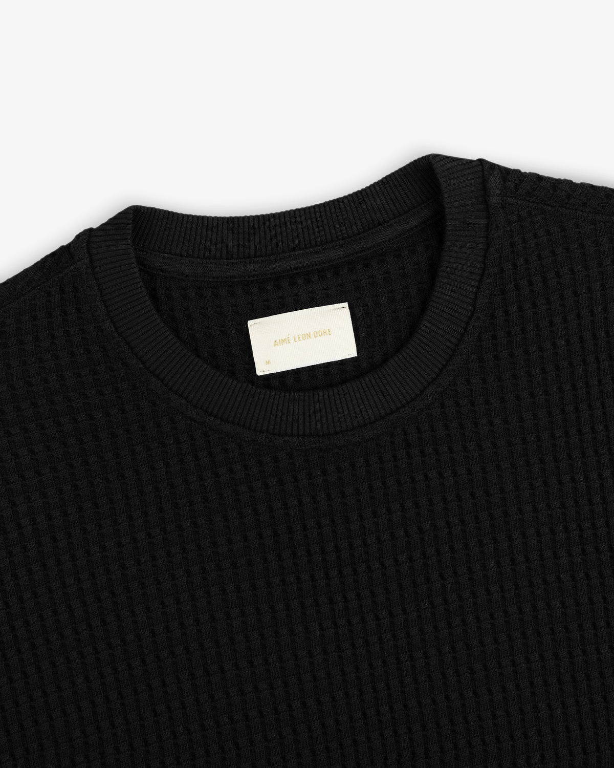 Close-up of a black Long-Sleeve Waffle Thermal shirt with a ribbed crew neckline.