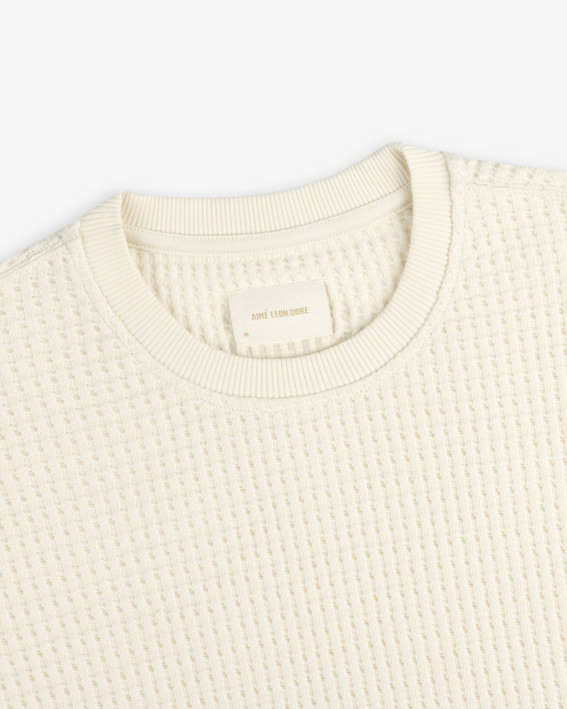 Cream-colored Long-Sleeve Waffle Thermal shirt with a waffle-knit texture and a clothing label inside the neckline.