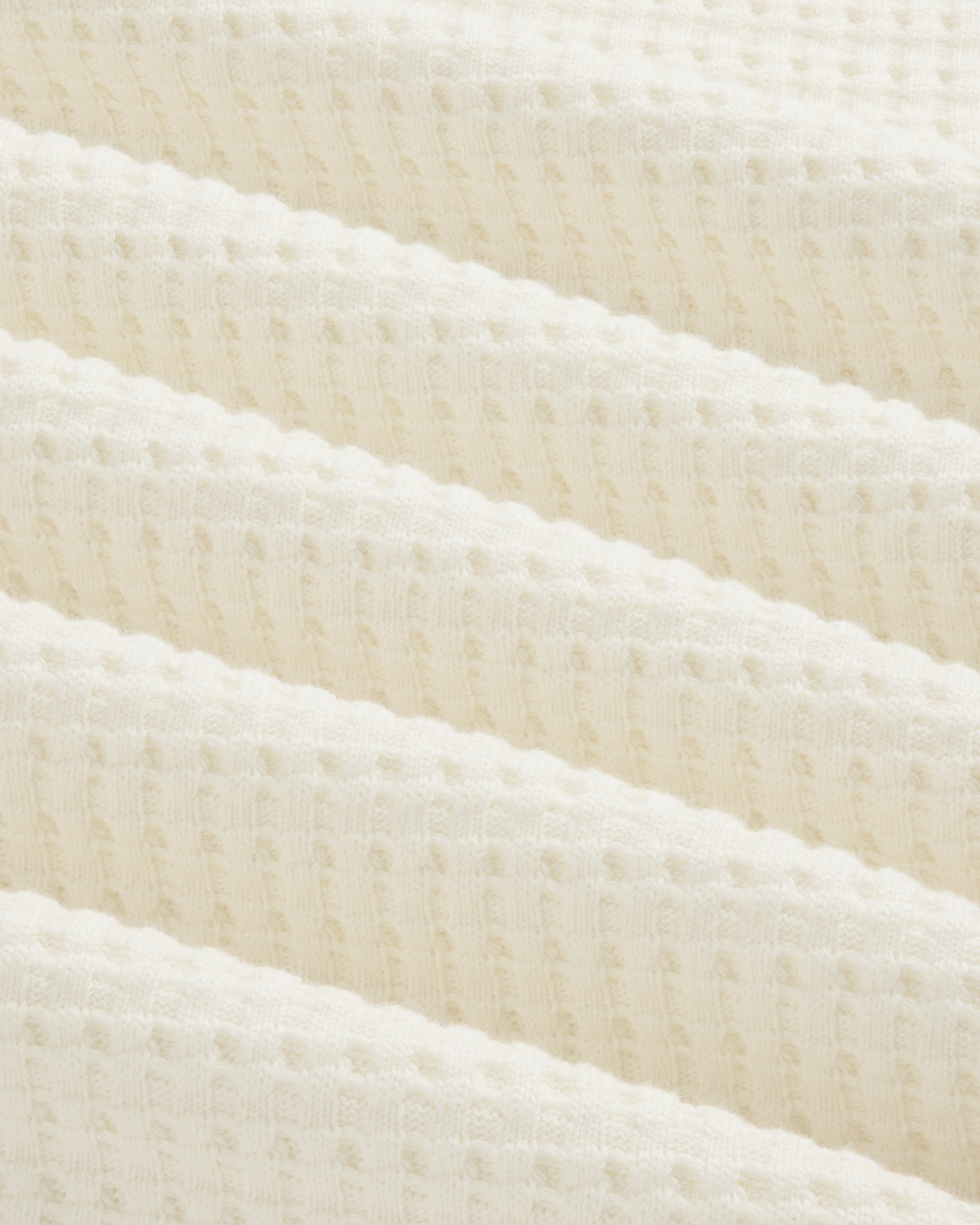 Close-up of an off-white Long-Sleeve Waffle Thermal in waffle-knit fabric with soft folds.