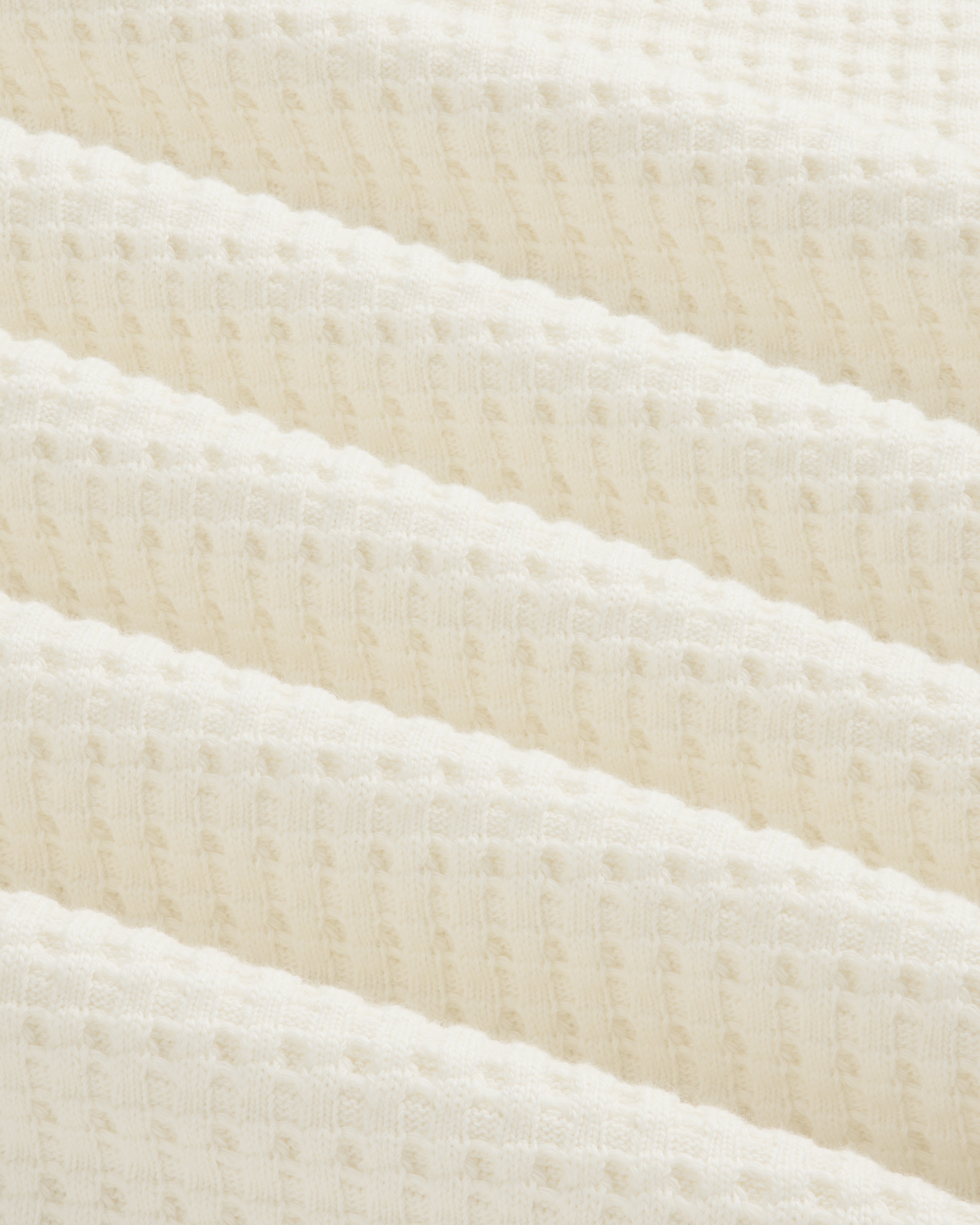 Close-up of an off-white Long-Sleeve Waffle Thermal in waffle-knit fabric with soft folds.