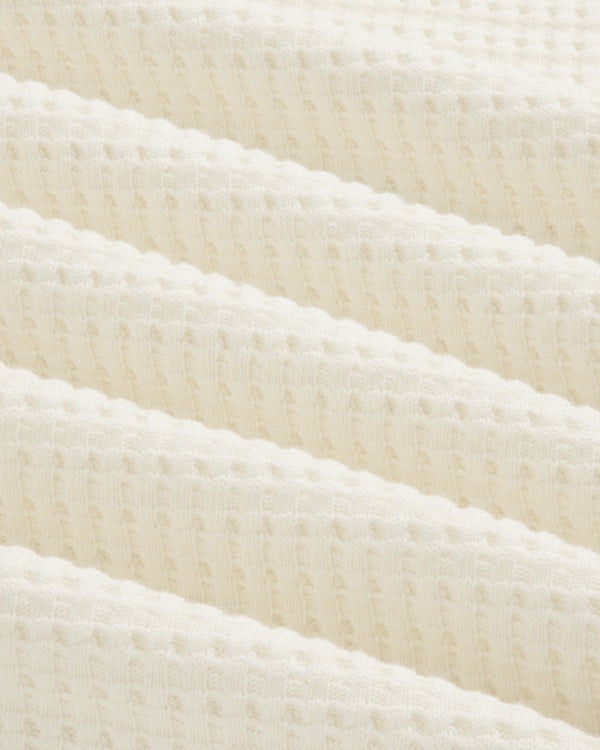 Close-up of an off-white Long-Sleeve Waffle Thermal in waffle-knit fabric with soft folds.