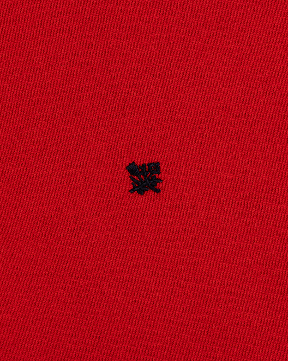 Red “Crest Rugby” fabric with a small, detailed black embroidered emblem at the center.